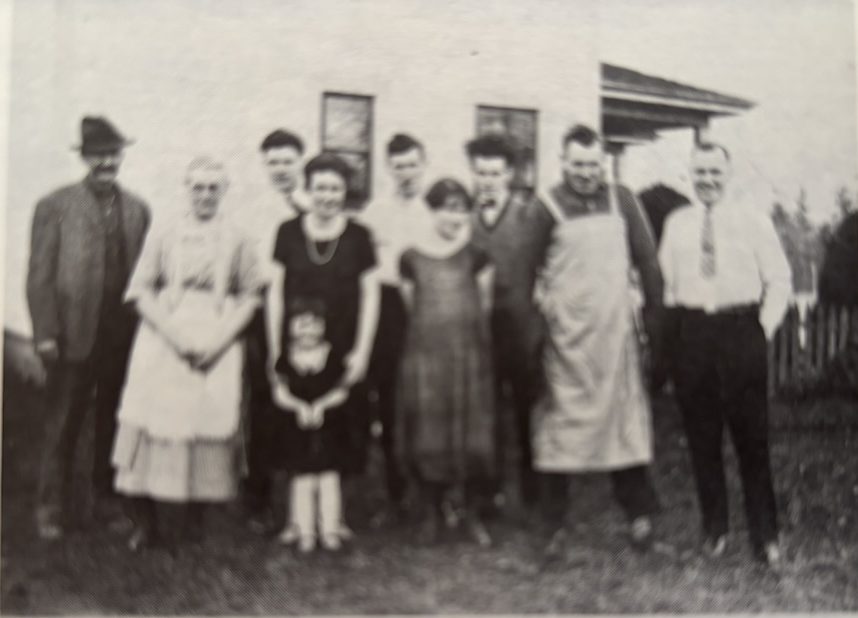 After the turkey, Christmas, 1925. George Atchison, Mrs. Atchison, Harry, Olive (Mrs. McRae) and Jean, Lorne, Rose, Clarke, Jim and Lloyd. Taken at side of Atchison home in Tynehead.